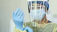 Close up of a female doctor wearing personal protective equipment (PPE) during the COVID-19 outbreak to protect from the transfer of germs.